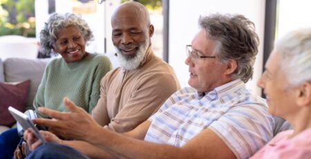 Group of elderly friends discussing their care options around estate planning.